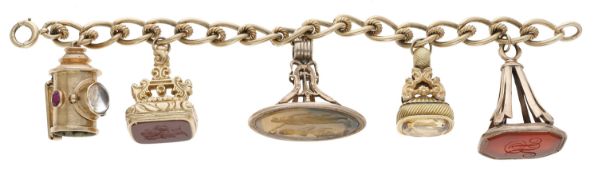 Shakespeare interest: A gold charm bracelet with fob seals, the fancy curb-link chain...