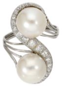 A cultured pearl and diamond ring, set with two cultured pearls with a scroll of single-cut...