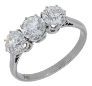 A diamond three stone ring, claw-set with old brilliant-cut diamonds, stamped 'PLAT', total...