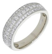 An 18ct gold and diamond dress ring, the tapered band set to the front with three rows of...
