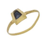 A Medieval sapphire ring, 14th century, the trapezoid bezel inset with a similarly shaped...