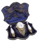 A 19th century shell cameo brooch and earring suite, circa 1865, the oval brooch relief...
