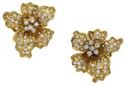 A pair of diamond en tremblant flowerhead ear clips, naturalistically modelled, the petals...