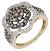 A diamond dress ring, of flowerhead design, set throughout with brilliant and single-cut...