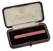 An enamel bar brooch, the pink guilloch&eacute; enamel panel within fluted border, stamped '14K',...