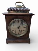 C19 Mahogany cased brass face mantle clock, bevelled glass cover with gadrooned bell top & brass car
