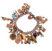A 9CT GOLD CHARM BRACELET
