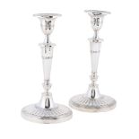 A PAIR OF SILVER CANDLESTICKS