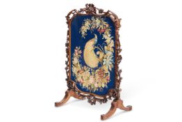 A VICTORIAN CARVED WALNUT FIRE SCREEN, CIRCA 1860