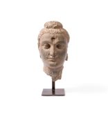 A GANDHARAN GREY SCHIST HEAD OF BUDDHA PESHAWAR VALLEY, PAKISTAN, 3RD OR 4TH CENTURY