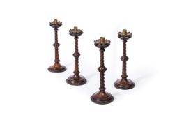 A SET OF FOUR VICTORIAN OAK GOTHIC REVIVAL CANDLESTICKS, LATE 19TH CENTURY