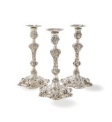 A SET OF THREE GEORGE III CAST SILVER CANDLESTICKS