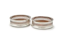 A PAIR OF SILVER MOUNTED BOTTLE COASTERS