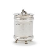 A SILVER HAMMERED JAR AND COVER
