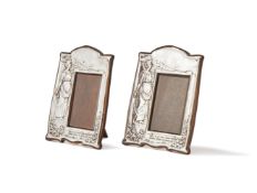 A PAIR OF EDWARDIAN SILVER MOUNTED PHOTO FRAMES