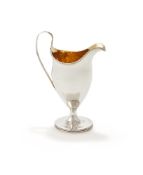 A GEORGE III SILVER CREAM JUG