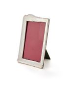 A SILVER MOUNTED SHAPED RECTANGULAR PHOTO FRAME