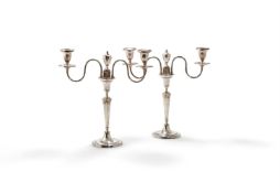 A PAIR OF GEORGE III SILVER CANDLESTICKS WITH OLD SHEFFIELD PLATED ARMS