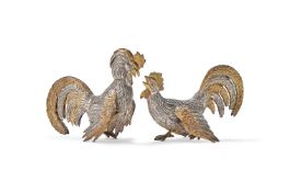 A PAIR OF SPANISH SILVER AND SILVER GILT COLOURED MODELS OF FIGHTING COCKERELS