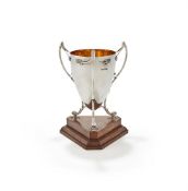 A SILVER THREE HANDLED CUP