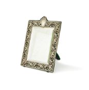 AN EDWARDIAN SILVER MOUNTED EASEL BACKED MIRROR