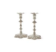A PAIR OF GEORGE II SILVER CAST CANDLESTICKS