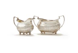 A GEORGE III SILVER LOBED OBLONG BALUSTER SUGAR BOWL AND MILK JUG