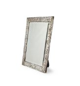 AN EDWARDIAN SILVER MOUNTED EASEL BACKED MIRROR