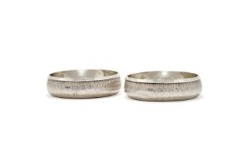 GERALD BENNEY, A PAIR OF SILVER AND SILVER GILT COASTERS