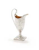 A GEORGE III SILVER HELMET SHAPED CREAM JUG