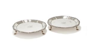 A PAIR OF GEORGE III SILVER SHAPED CIRCULAR WAITERS