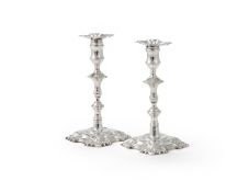A PAIR OF GEORGE II CAST SILVER CANDLESTICKS