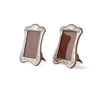 A PAIR OF SILVER MOUNTED SHAPED OBLONG PHOTO FRAMES