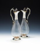 A PAIR OF VICTORIAN SILVER MOUNTED GLASS CLARET JUGS