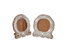 A MATCHED PAIR OF EDWARDIAN SILVER MOUNTED PHOTO FRAMES