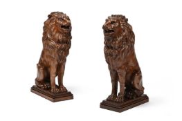 A PAIR OF ITALIAN CARVED WALNUT LIONS, 19TH CENTURY