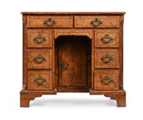 A GEORGE II FIGURED BURR WALNUT KNEEHOLE DESK, CIRCA 1735