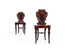A PAIR OF GEORGE IV CARVED MAHOGANY HALL CHAIRS, IN THE MANNER OF GILLOWS, CIRCA 1830