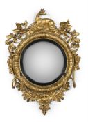 A REGENCY CARVED GILTWOOD CONVEX WALL MIRROR, CIRCA 1815