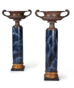 A PAIR OF CAST IRON TWIN HANDLED URNS ON COLUMN BASES, 19TH CENTURY