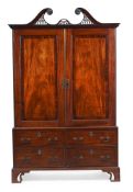 A GEORGE III MAHOGANY CLOTHES PRESS, IN THE MANNER OF WILLIAM BRADSHAW, CIRCA 1780