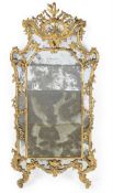 A LARGE CONTINENTAL CARVED GILTWOOD MIRROR, FIRST HALF 18TH CENTURY