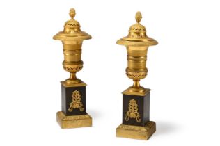 A PAIR OF FRENCH SECOND EMPIRE GILT AND PATINATED BRONZE CASSOLETTE URNS, CIRCA 1860