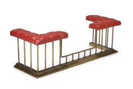 A RED LEATHER BUTTON UPHOLSTERED AND BRASS CLUB FENDER, MODERN