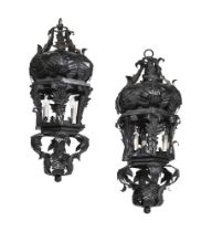 A PAIR OF BLACK PAINTED WROUGHT IRON SCROLLING LEAF DECORATED LANTERNS, LATE 20TH CENTURY
