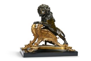 A GILT AND PATINATED ANIMALIER BRONZE, IN THE MANNER OF A RÉGENCE CHENET, 19TH CENTURY