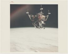 [Apollo 9] LM SPIDER FLOATS UPSIDE DOWN OVER EARTH DURING ITS MAIDEN FLIGHT