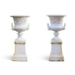 A PAIR OF CAST IRON URNS ON STANDS IN THE HANDYSIDE MANNER, LATE 19TH/EARLY 20TH CENTURY