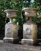A PAIR OF TERRACOTTA URNS ON PEDESTALS, ATTRIBUTED TO PULHAM, LATE 19TH CENTURY