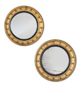 A MATCHED PAIR OF REGENCY GILTWOOD CONVEX MIRRORS, CIRCA 1815